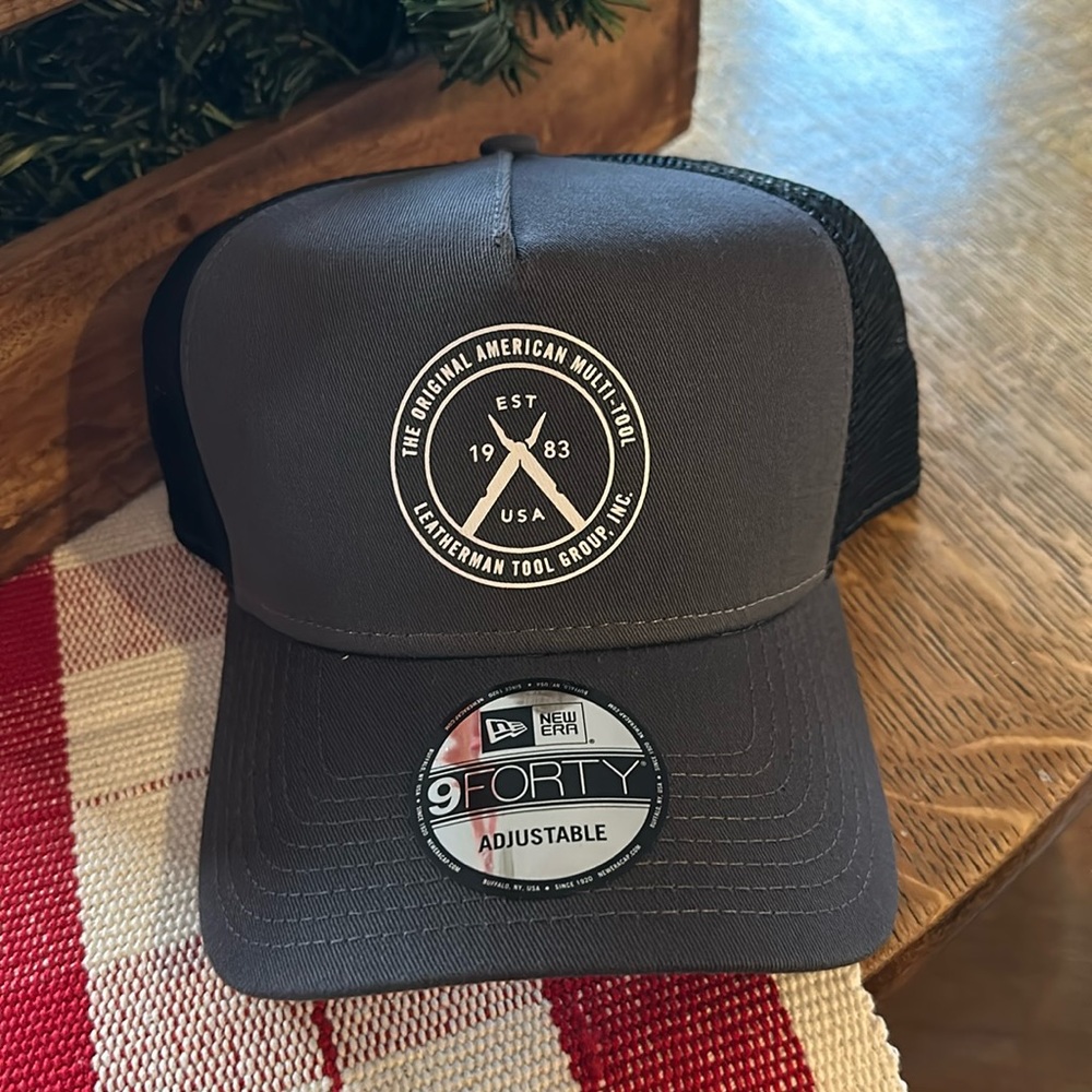 NWT Leatherman logo Trucker snap back hat. Dark gray with black mesh back.
